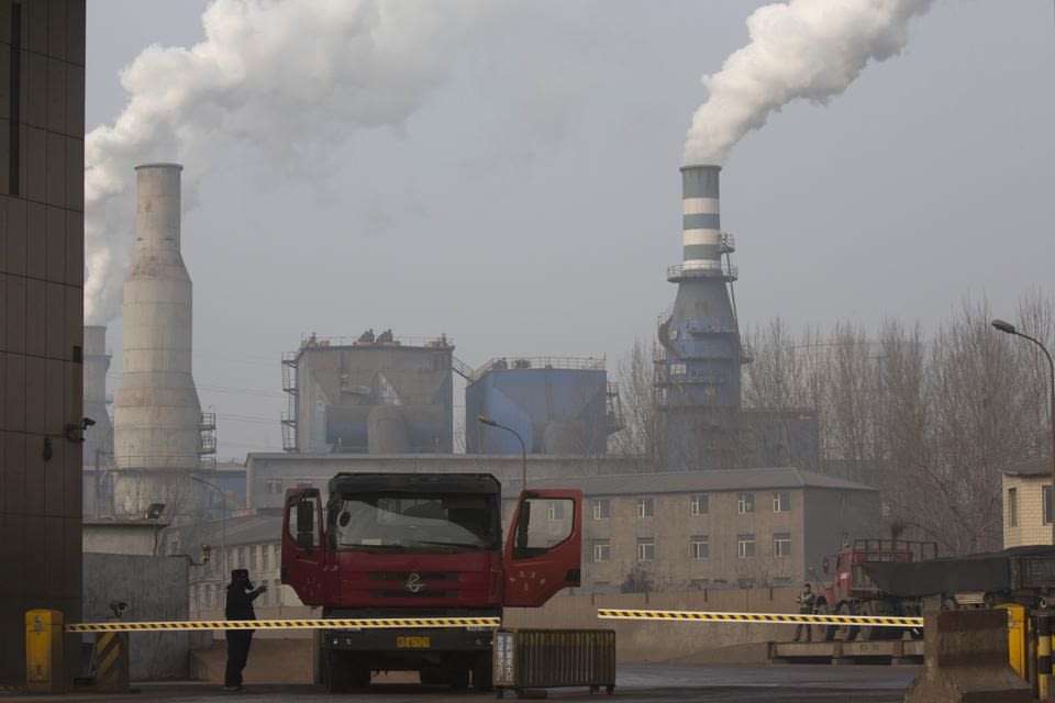 In this Dec. 30, 2016 photo, a truck leaves with metal products from the sprawling complex that is a part of the Jiujiang steel and rolling mills in Qianan in northern China's Hebei province. Faced with choking smog in the Chinese capital, Chinese media and policy circles often point to a list of culprits: the central government's inability to shut down polluting steel mills, the middle class's insatiable demand for cars, poorer segments of society's insistence on burning coal. (AP Photo/Ng Han Guan)